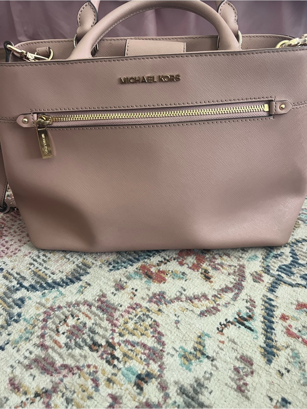 Michael Kors blush pink. Sleek design with top handles and a crossbody strap.